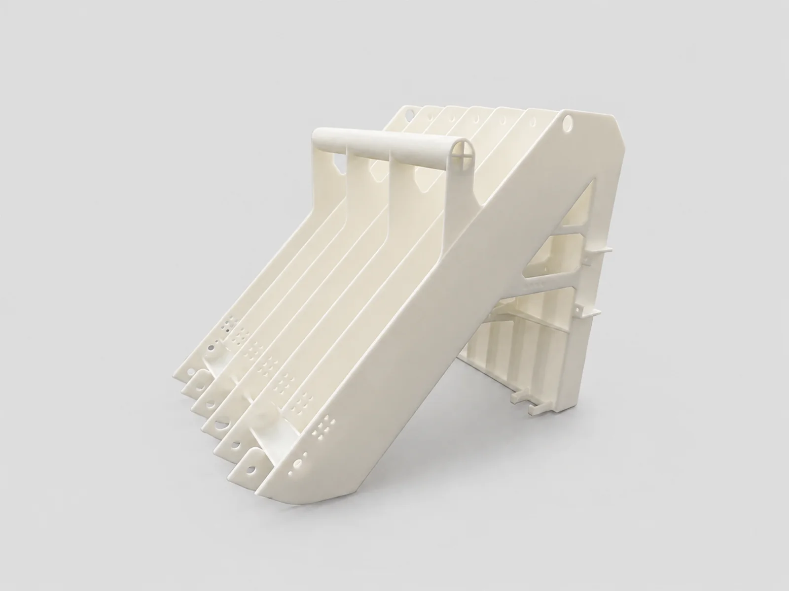 3D printed prototype parts beside an industrial additive manufacturing system