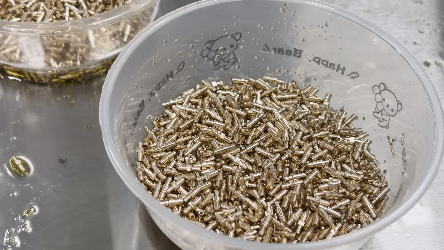 Production quantity of finished micro-turned brass connector contacts after machining