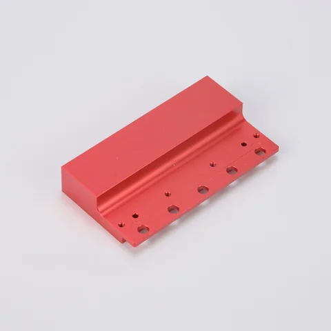 Red aluminum bracket illustrating visible faces, edges and threaded features to identify in a finishing specification