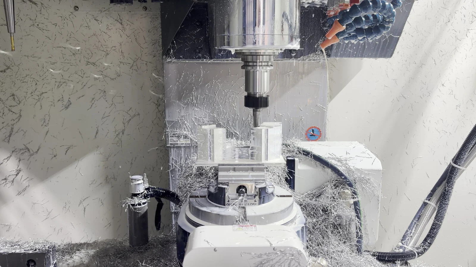 CNC spindle cutting an aluminum part after the rotary table has indexed to a fixed machining orientation