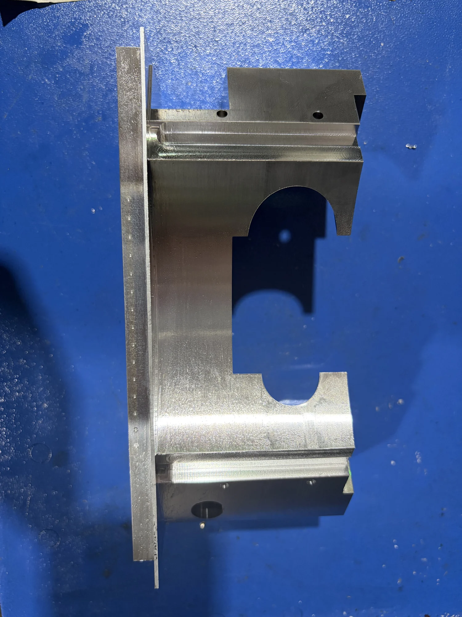 Intermediate multi-face aluminum part with the temporary dovetail clamping portion still attached