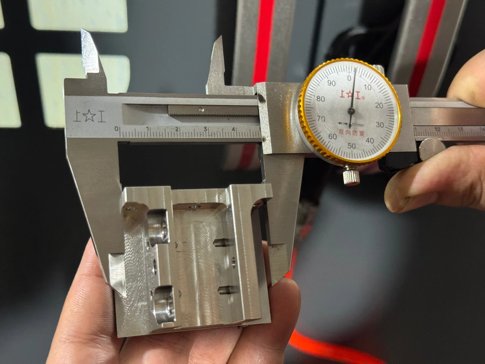 Manual caliper check of a machined feature during the 304 stainless steel production run