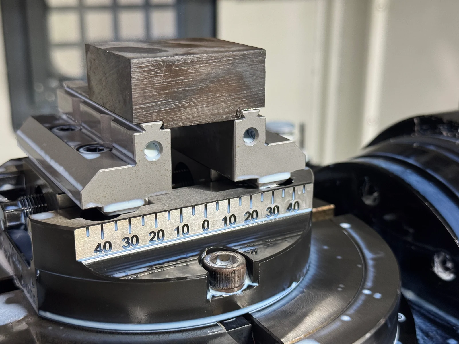 Close view of the workpiece and locating fixture used for multi-face 3+2 CNC machining