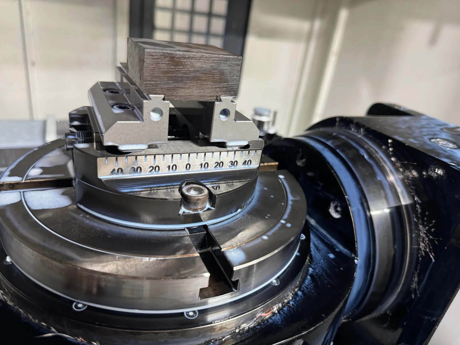 Rectangular 304 stainless steel stock held on an indexed rotary-table fixture