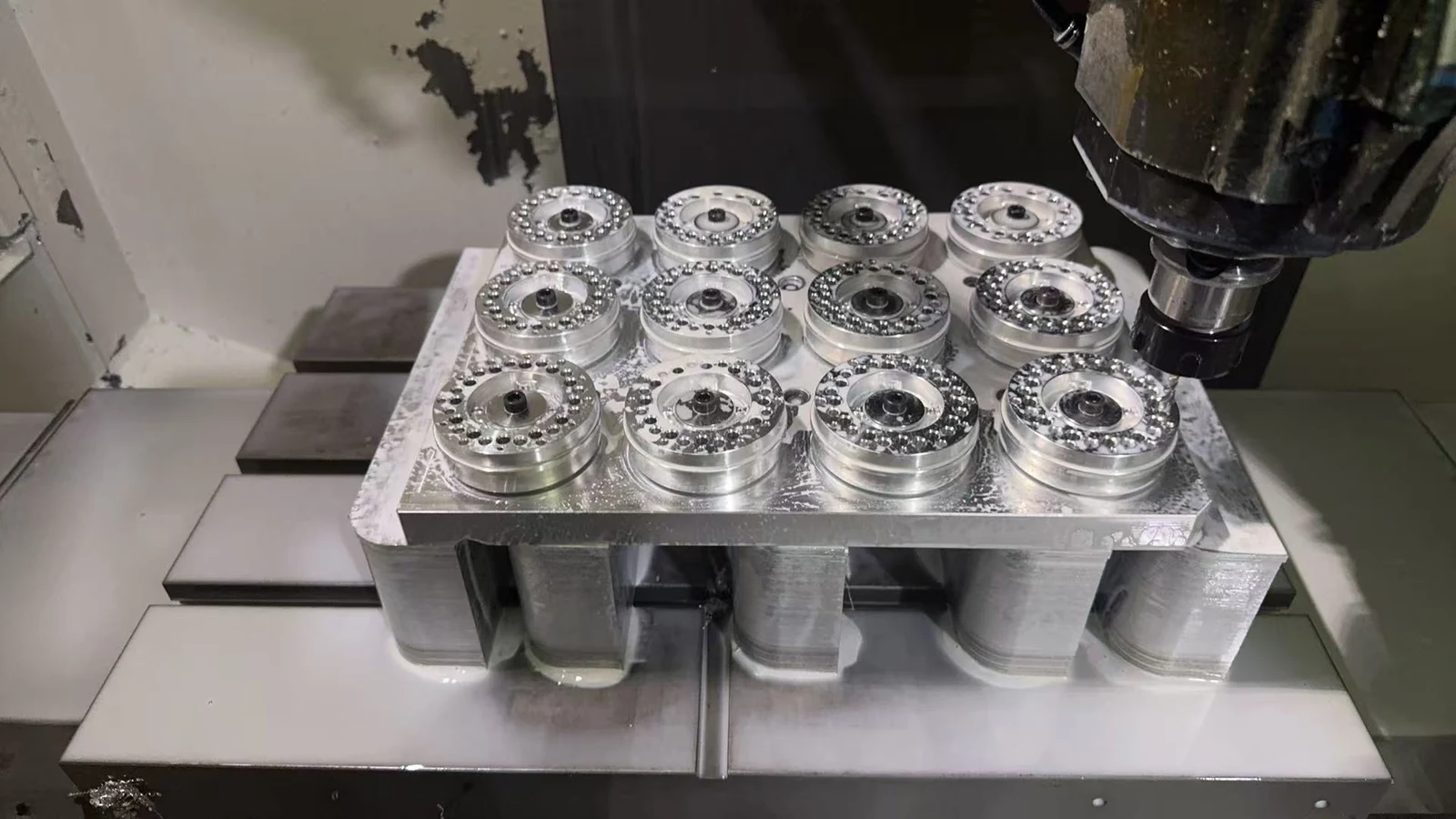 Twelve robot gearbox planet carriers located on a dedicated CNC milling fixture