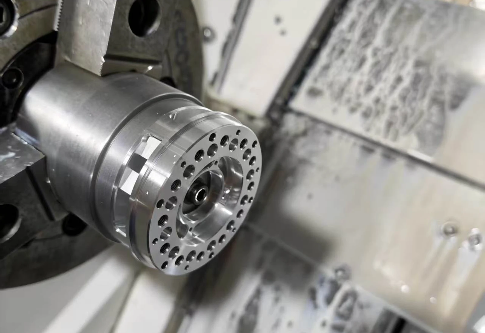 7075-T6 robot gearbox planet carrier held in soft jaws on a CNC lathe
