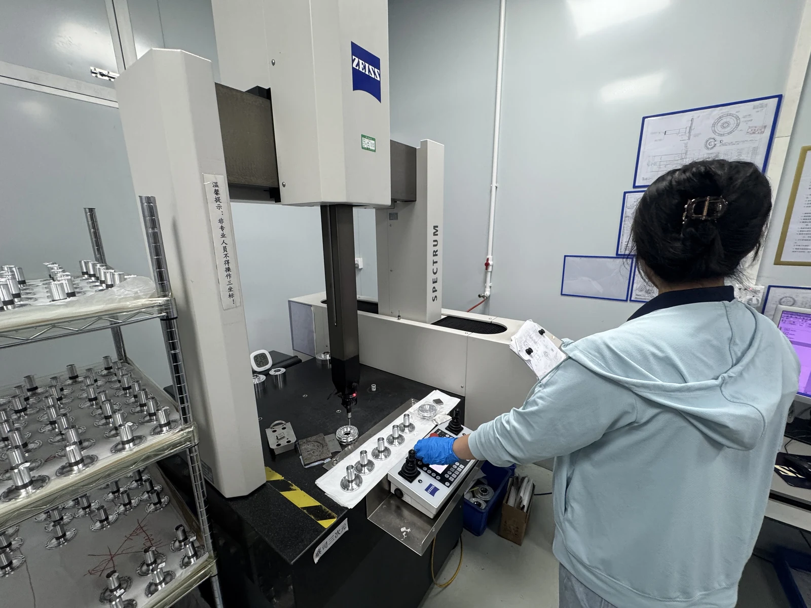 Quality technician inspecting an aluminum planet carrier on a ZEISS SPECTRUM coordinate measuring machine