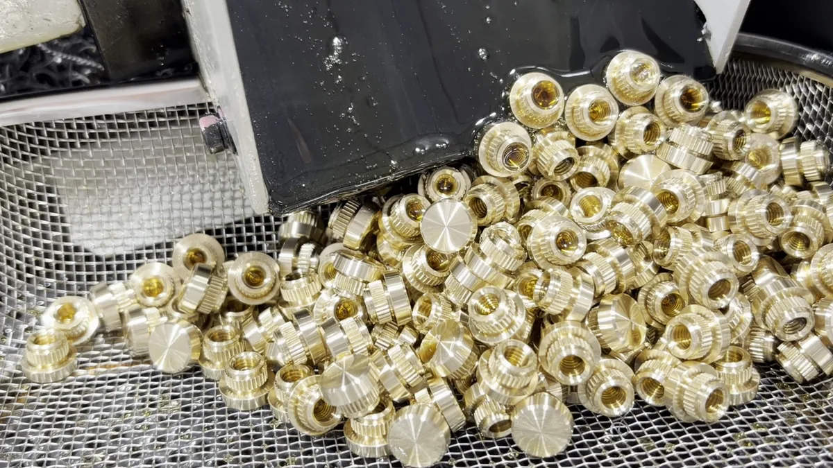 C3604 threaded brass parts collected at the machine outfeed during production