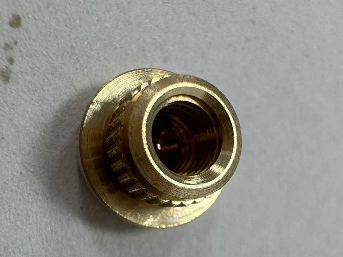 Actual C3604 brass part with internal thread, straight knurling and stepped outer geometry