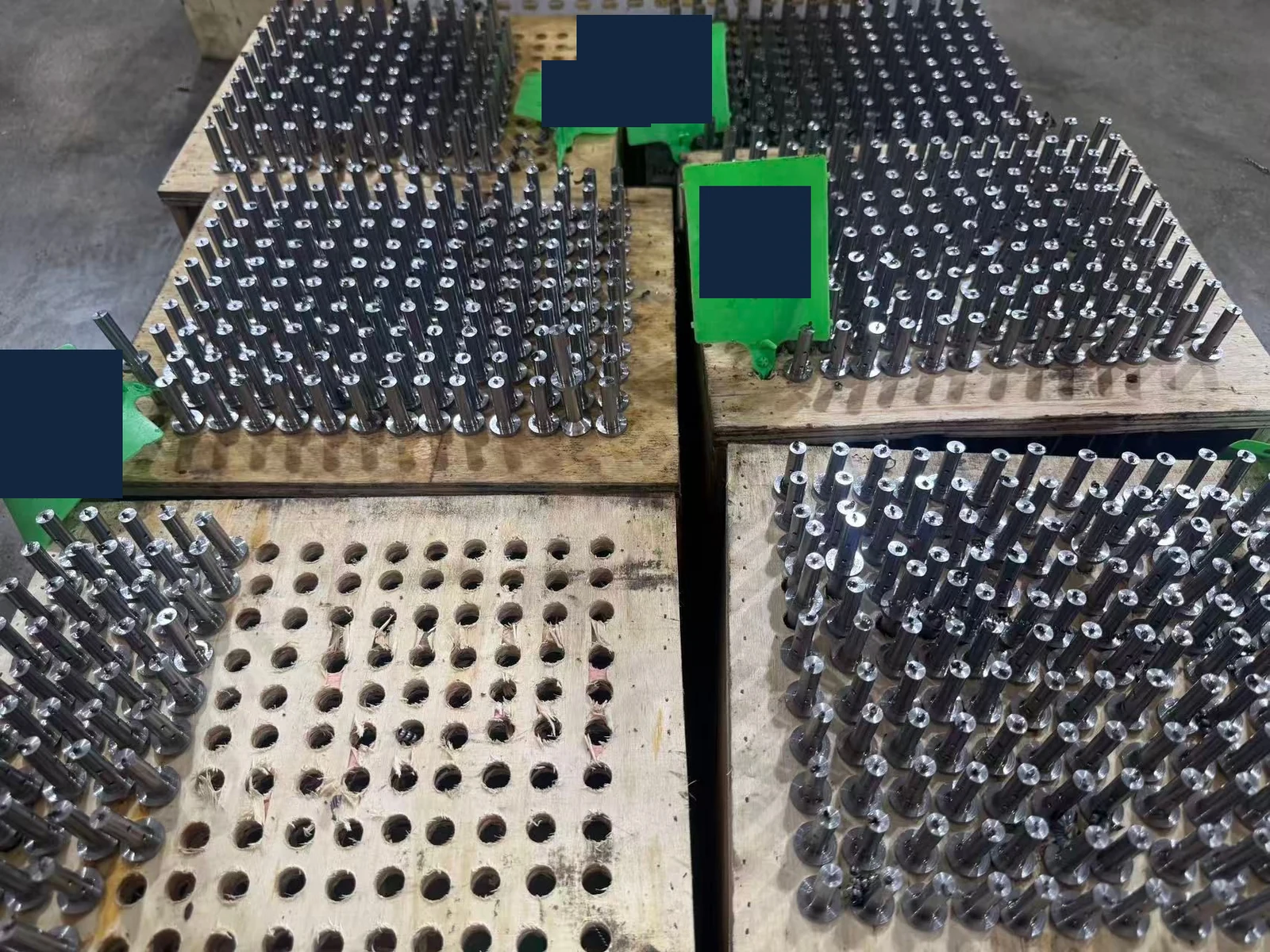 SUS431 parts grouped on holding boards with green heat-number labels; identifying values are covered