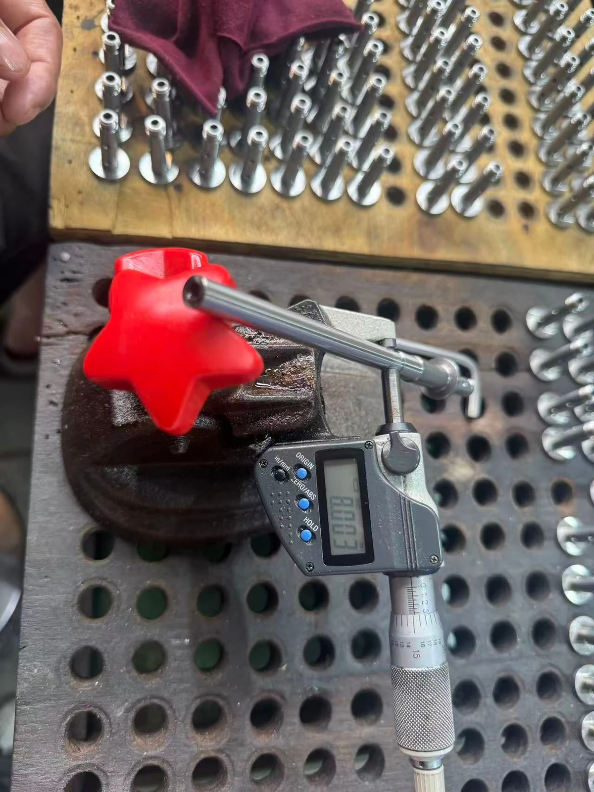 Digital outside micrometer displaying 8.003 mm while checking a SUS431 shaft diameter