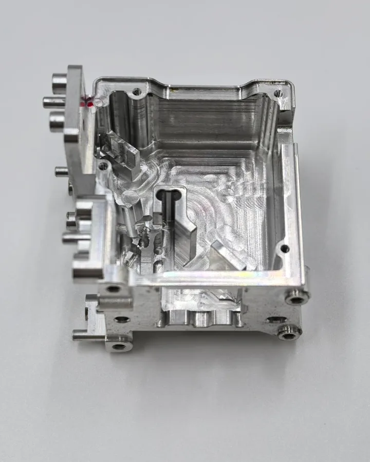 Real OUJI open machined housing with internal cavities, mounting holes and projecting features