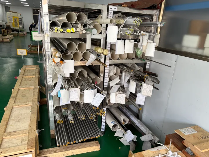 OUJI raw material rack with grade labels and identification tags on bar stock