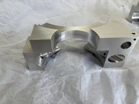 Multi-face EN AW-6082 aluminum component after 3+2 indexed CNC machining and removal of the temporary dovetail clamping feature