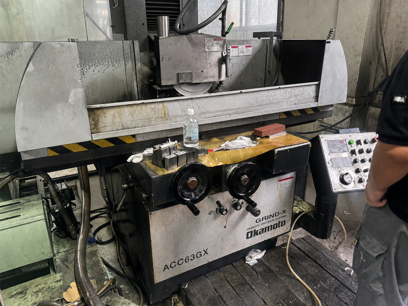 Detailed grinding setup showing wheel, workpiece and coolant control
