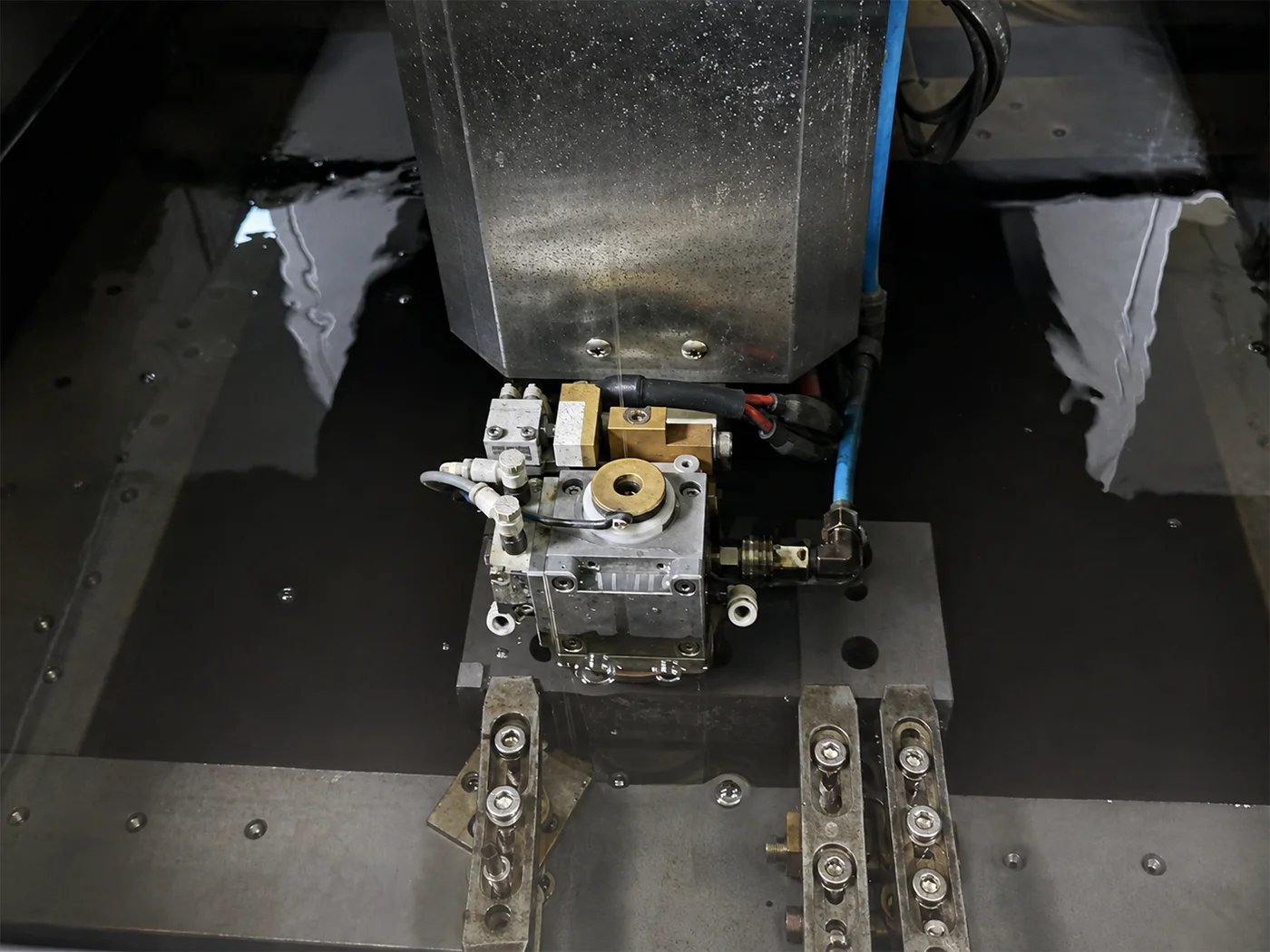 Close-up detail of Wire EDM cutting a conductive metal profile